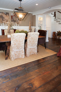  A beautifully designed dining room featuring reclaimed wood flooring, surrounded by antique decor that enhances its timeless charm. Each plank is crafted end to end in our workshop. All Done In house, Our house. 